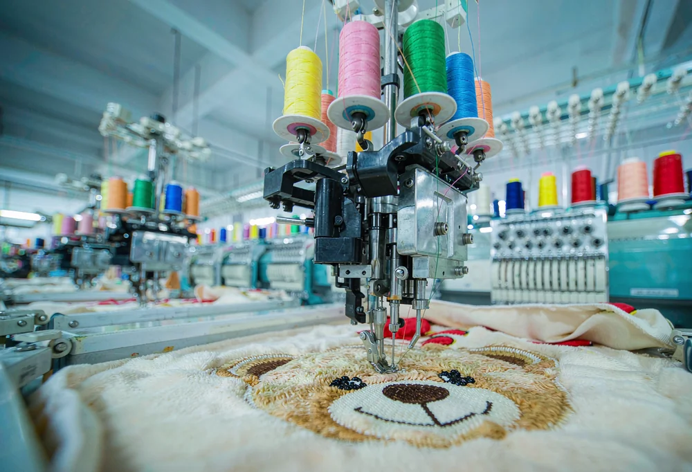 Computerized embroidery machines stitching plush faces
