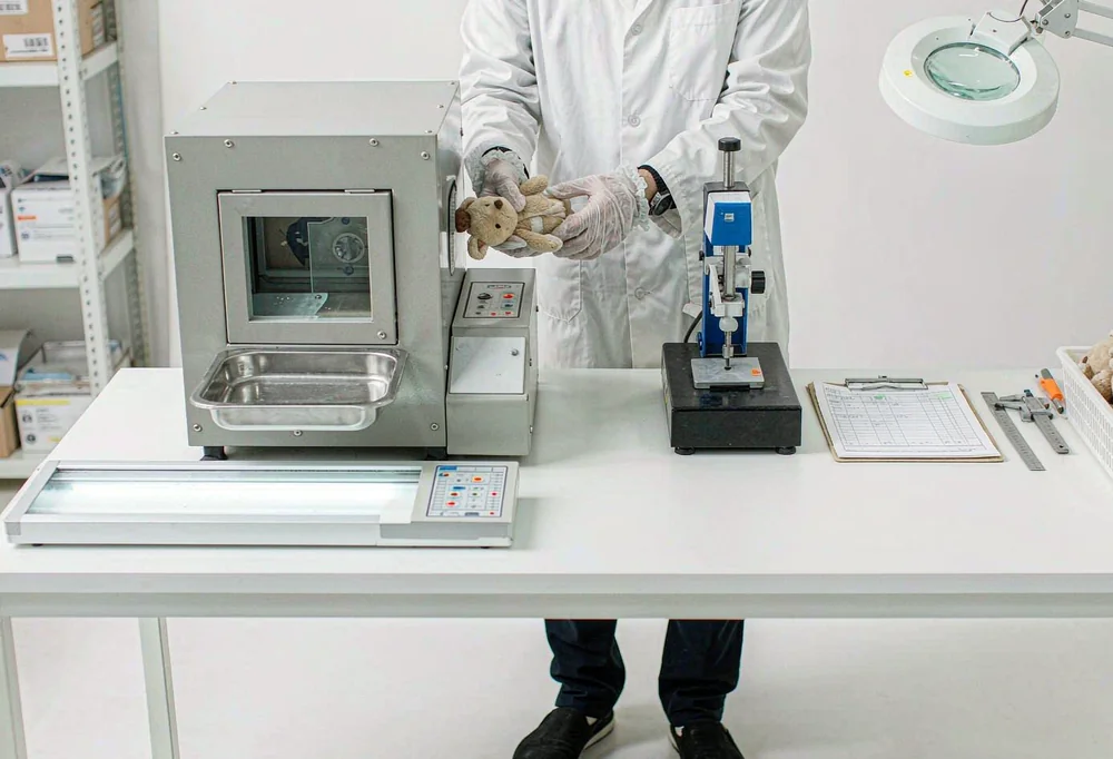 Quality inspectors checking plush with metal detector