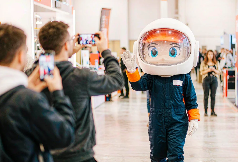Corporate mascot at a trade show booth
